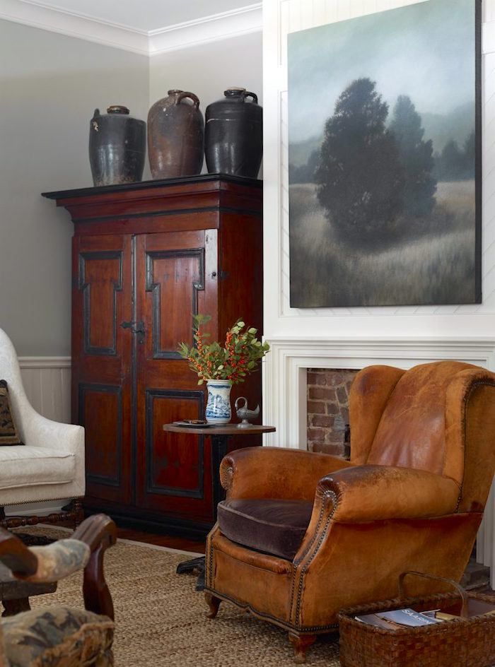 Barbara-Westbrook-Atlanta-Bungalow-via-Garden-and-Gun-Armoire-for-the-TV-painting-over-fireplace.jpg