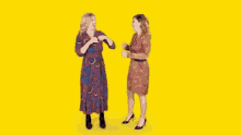 GIF--Cartoon--Two-Standing-Women--Slightly-Wiggling-Down-and-Up--Happy-Together.gif