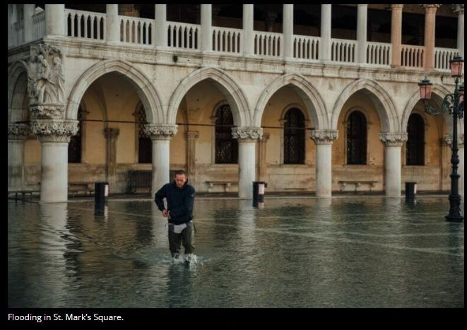 pic--Former-St Marcus-Square--man--wading-thru-flooding.jpg